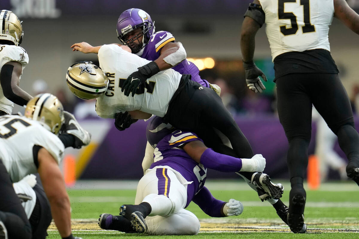 New Orleans Saints quarterback Derek Carr (4) is hit by Minnesota Vikings linebacker Danielle H ...