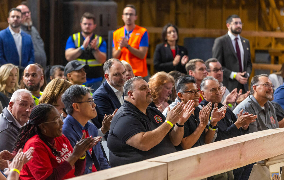 Invited guests applaud as President Joe Biden speaks about unions during a gathering at the Car ...