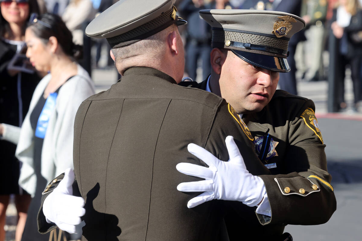 Law enforcement officers hug during the memorial for Nevada Highway Patrol trooper Alberto Feli ...