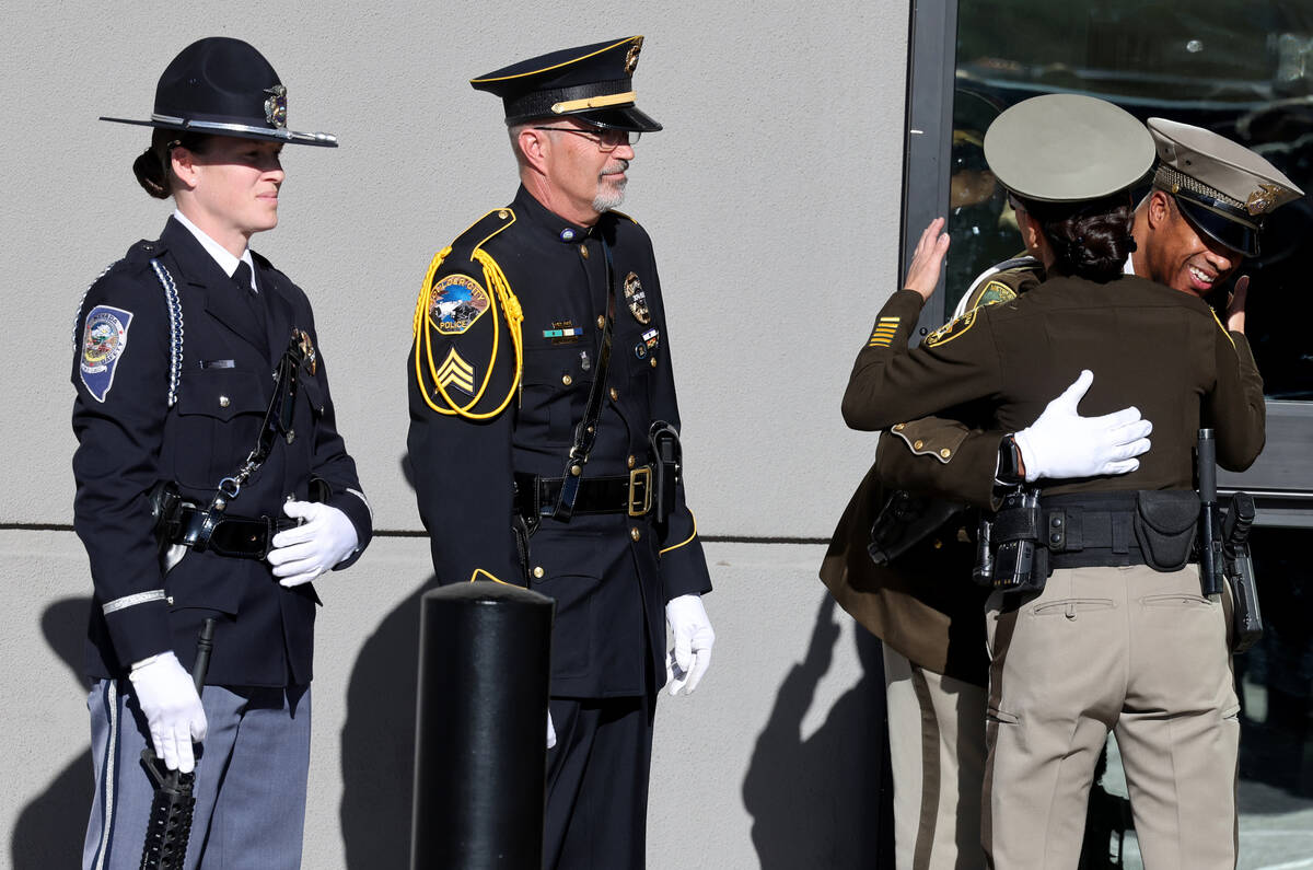 Law enforcement officers hug during the memorial for Nevada Highway Patrol trooper Alberto Feli ...
