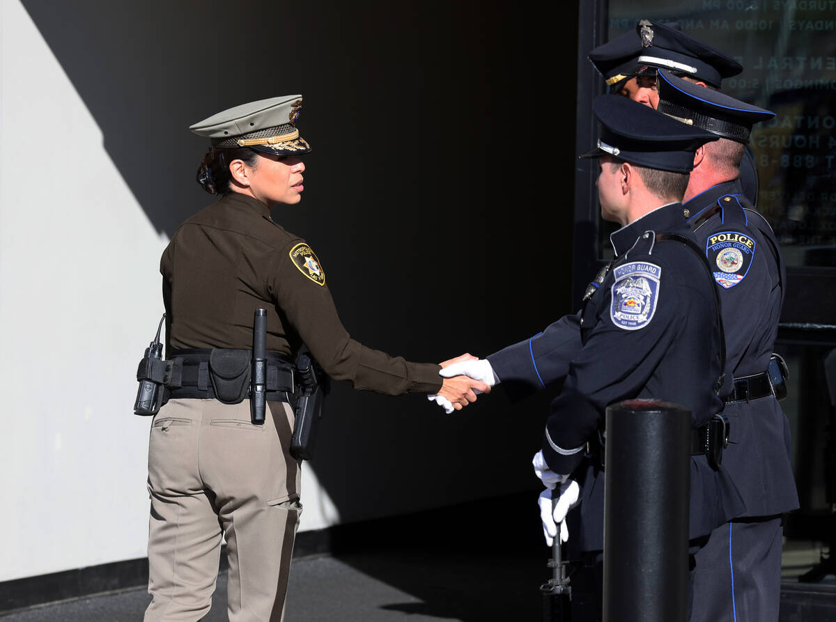 Law enforcement officers greet each other during the memorial for Nevada Highway Patrol trooper ...