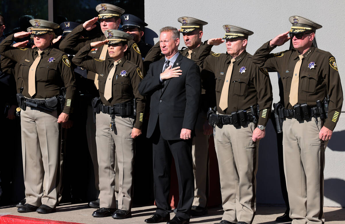 Law enforcement officers salute the casket during the memorial for Nevada Highway Patrol troope ...