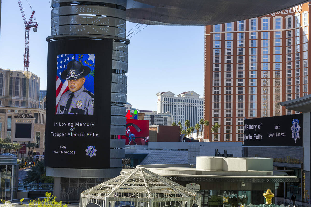 A tribute to Nevada State Trooper Alberto Felix is projected on a video screen at Fashion Show ...