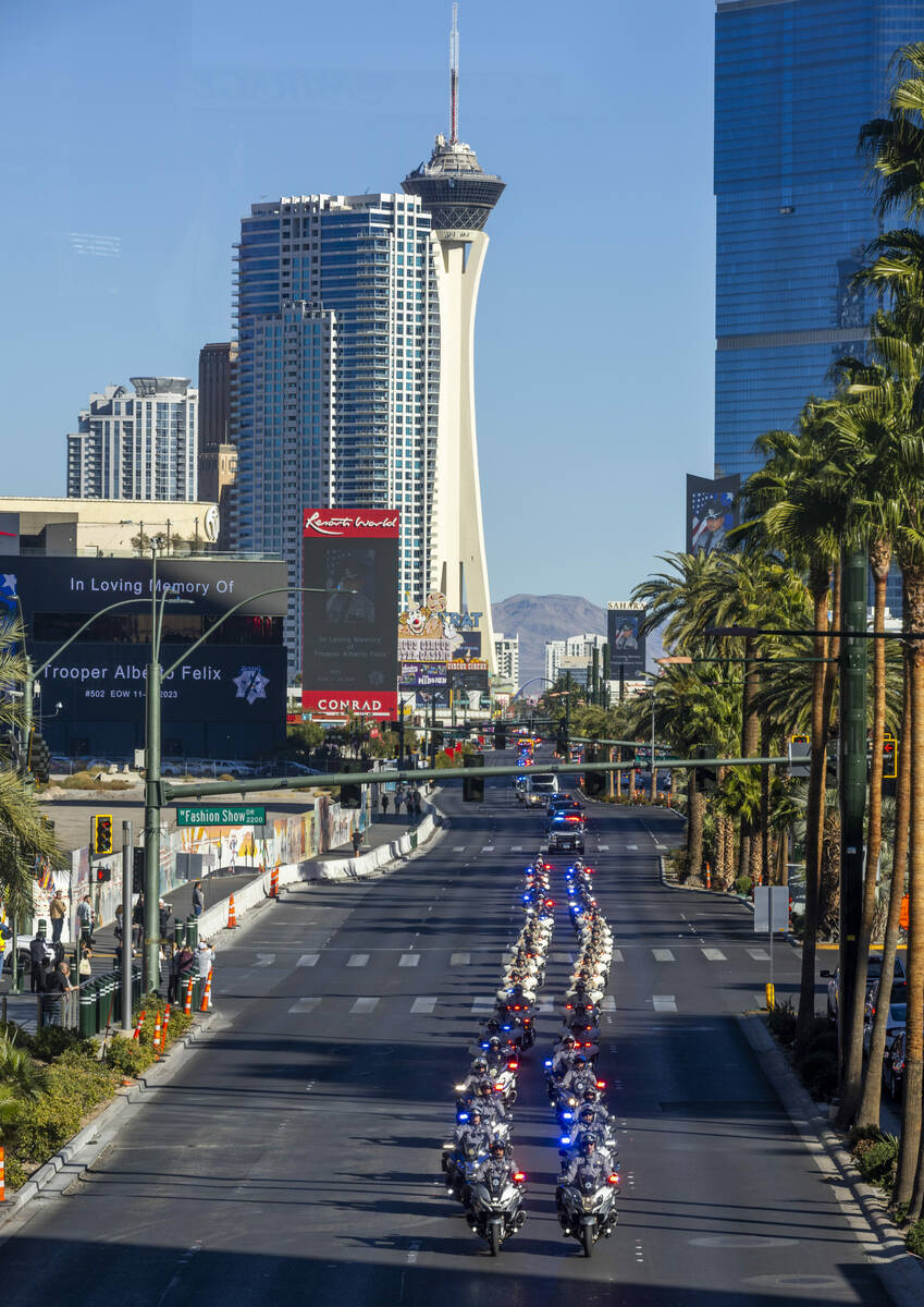 Police motorcycles lead a procession for Nevada State Trooper Alberto Felix down the Las Vegas ...