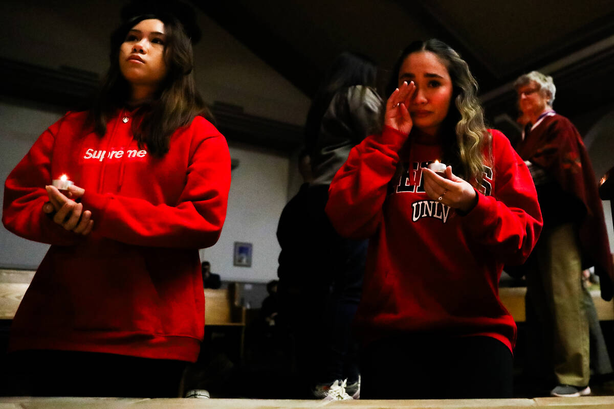 People mourn at a community prayer held for the victims of the Dec. 6 UNLV shooting, hosted at ...