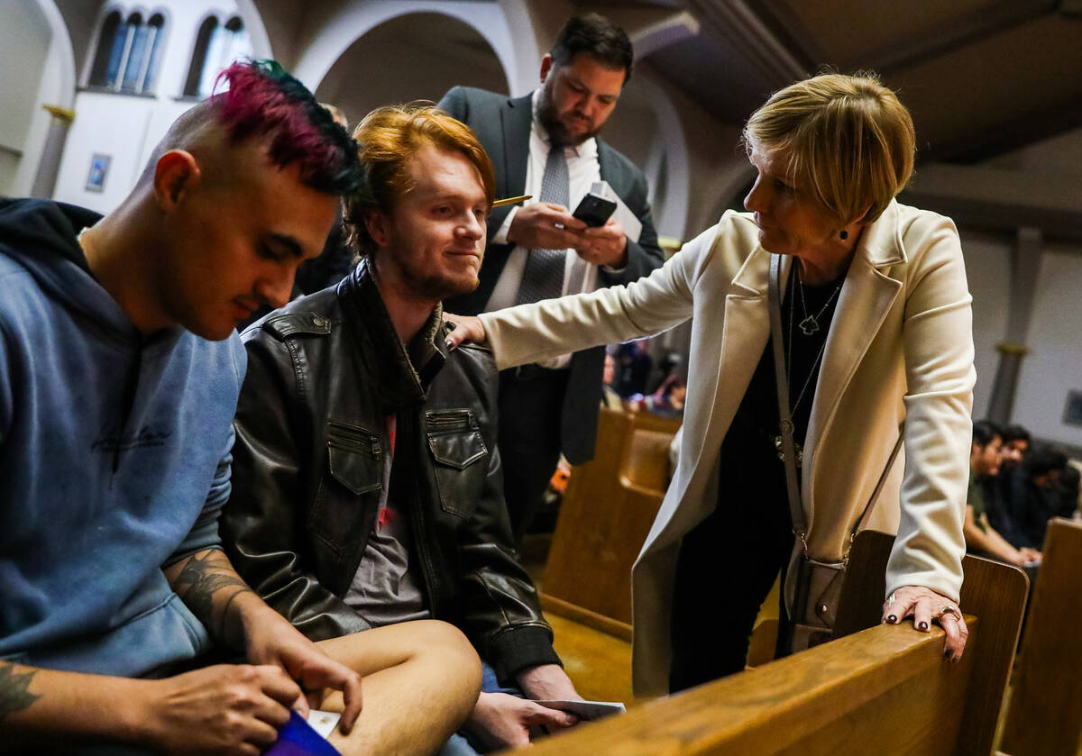 Congresswoman Susie Lee comforts Angel Maiorano, left, and Thomas Levings, UNLV students, at a ...