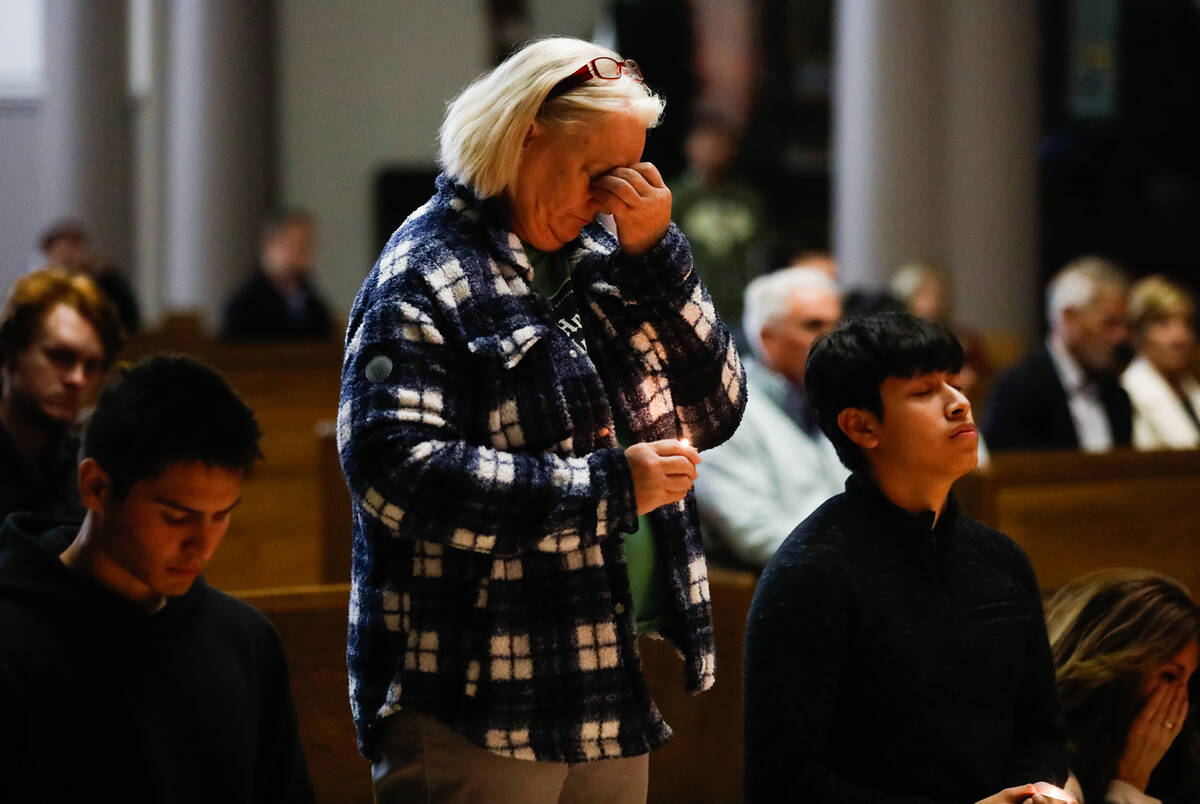 People mourn at a community prayer held for the victims of the Dec. 6 UNLV shooting, hosted at ...