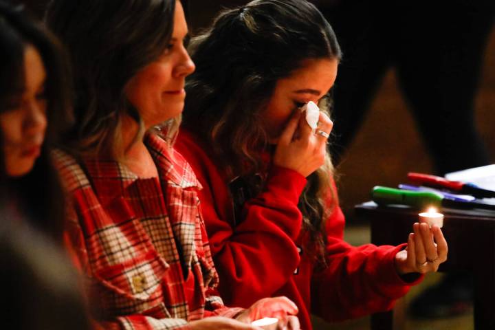 People mourn at a community prayer held for the victims of the Dec. 6 UNLV shooting, hosted at ...