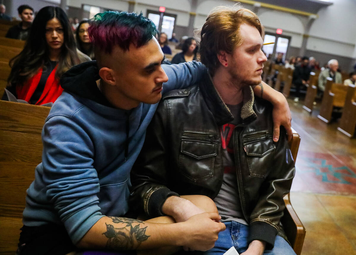 Angel Maiorano, left, and Thomas Levings, UNLV students, mourn at a community prayer held for t ...
