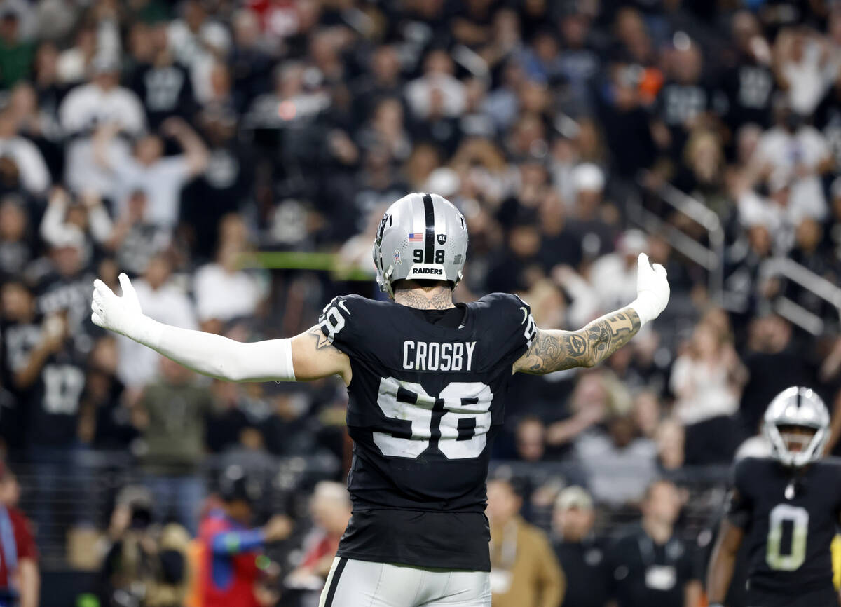 Raiders defensive end Maxx Crosby (98) directs fans to make noise during the second half of an ...