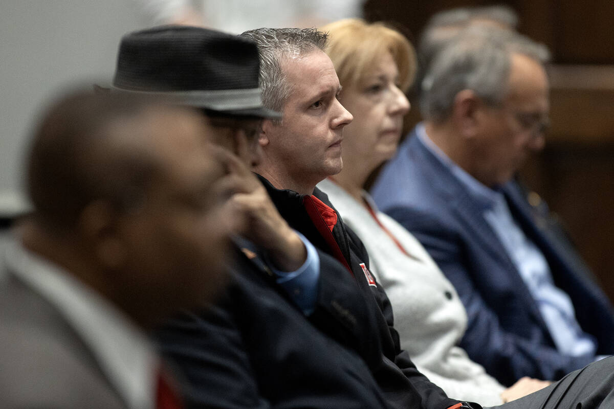 Jason Smith, department of accounting chair at UNLV, listens victims are memorialized following ...