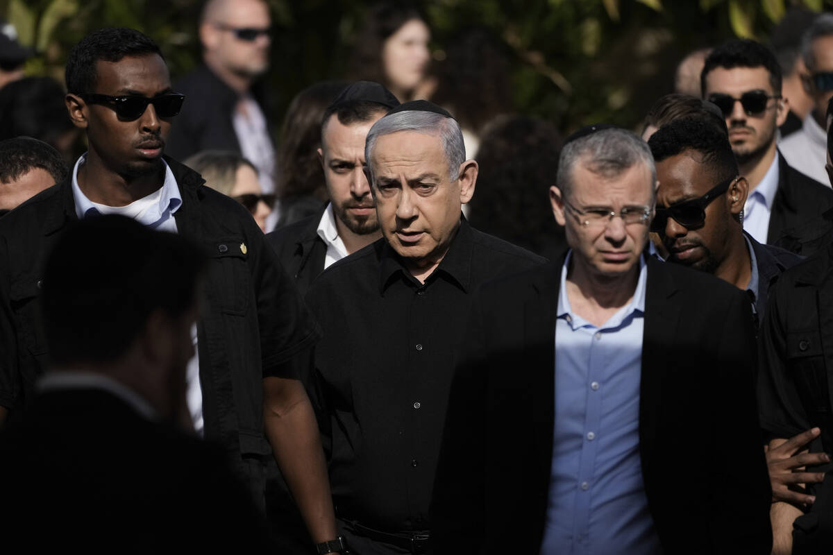 Israeli Prime Minister Benjamin Netanyahu, center, arrives for the funeral of Israeli soldier M ...