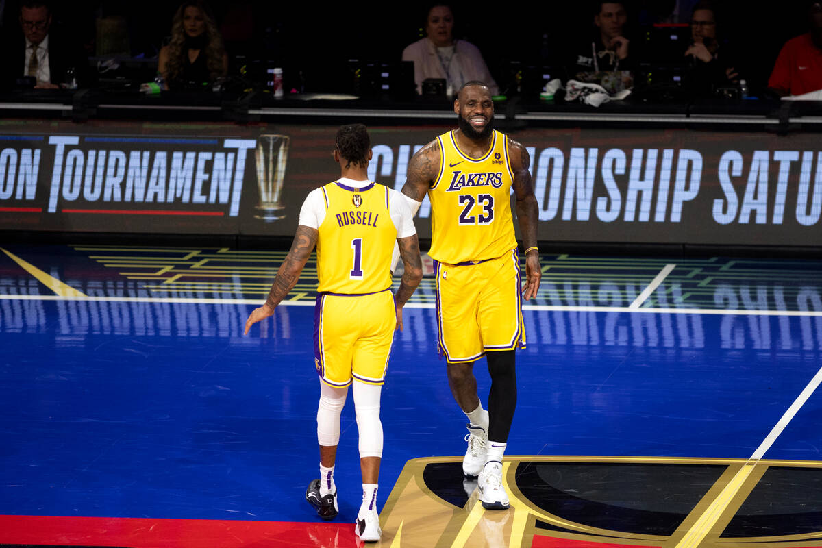 Los Angeles Lakers guard D'Angelo Russell (1) and forward LeBron James (23) slap hands during t ...