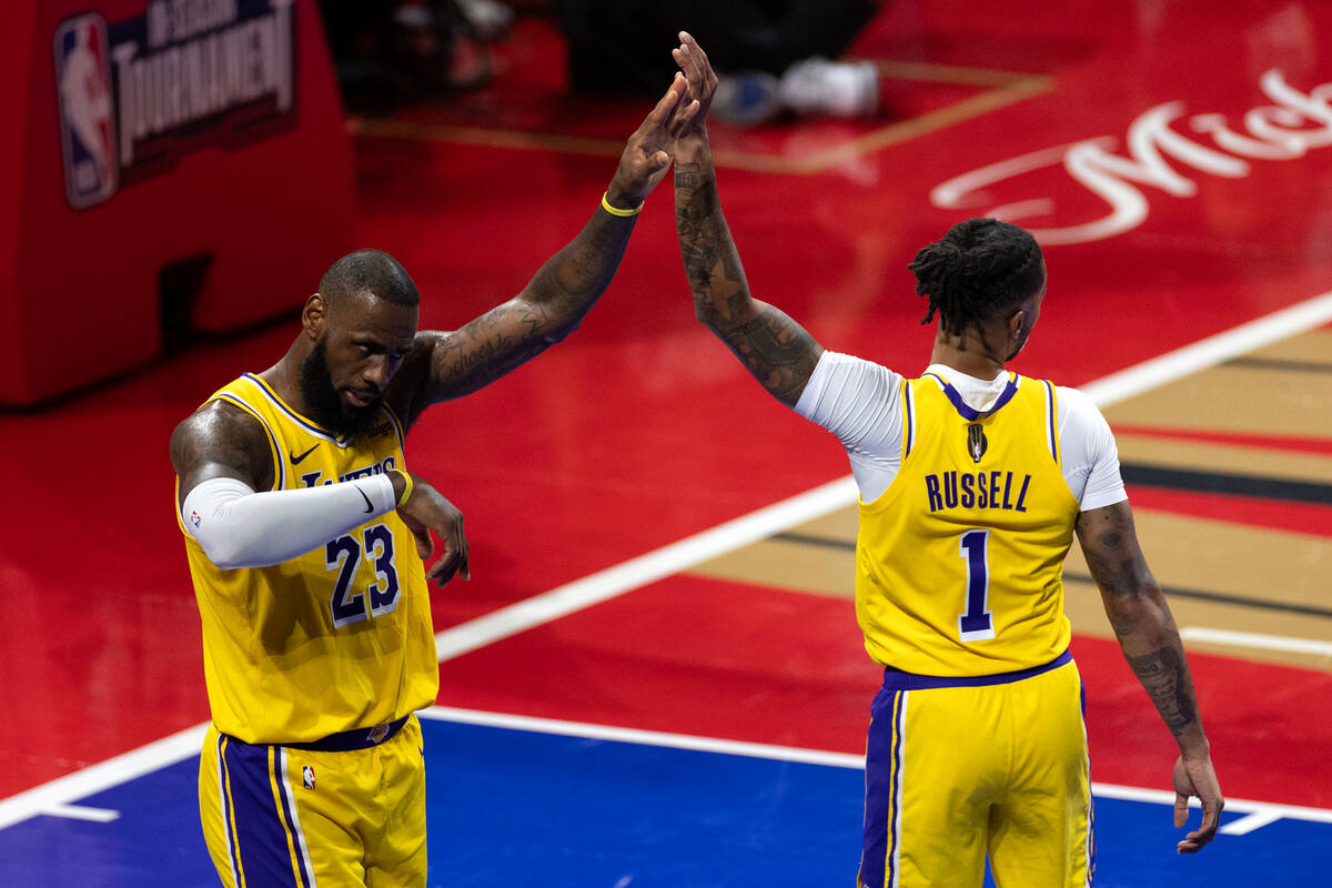 Los Angeles Lakers forward LeBron James (23) and guard D'Angelo Russell (1) slap hands during t ...