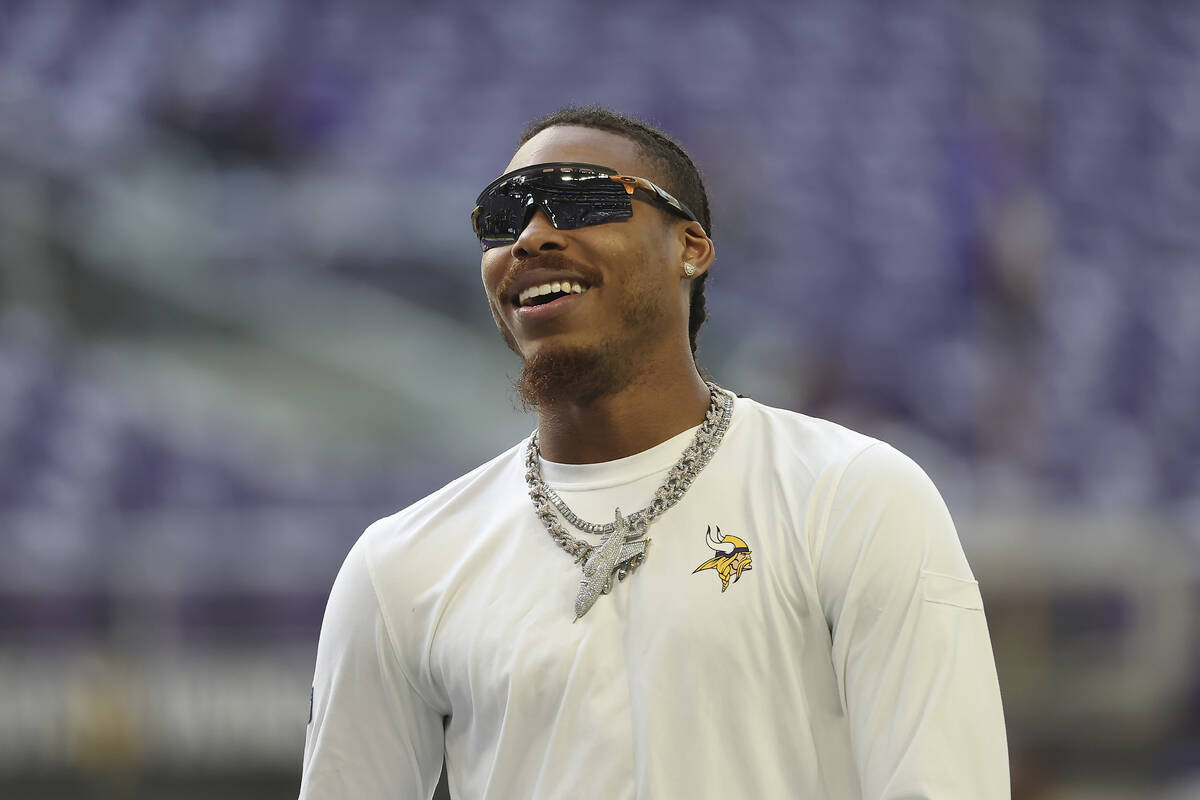 Minnesota Vikings wide receiver Justin Jefferson walks on the field before an NFL football game ...