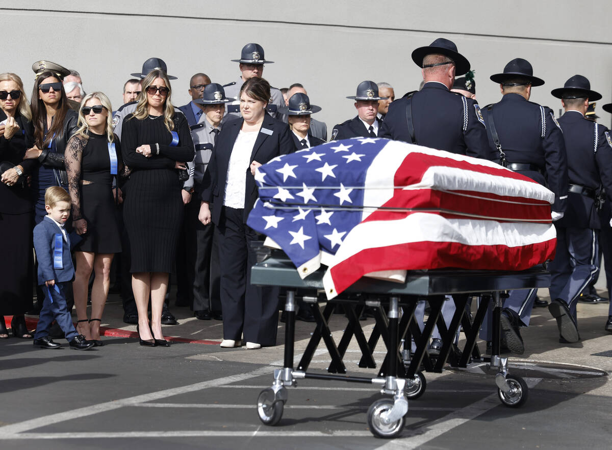 Vanessa Abbate, holding her 3-year-old son Vince, left, watches as the casket of her late husba ...