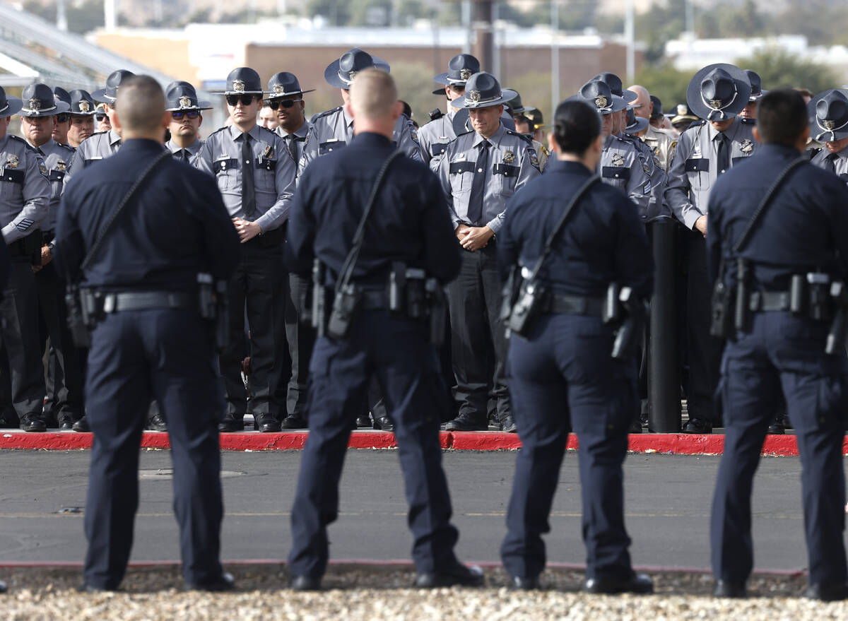 Law enforcement officers wait for the casket carrying Nevada Highway Patrol Sgt. Michael Abbate ...