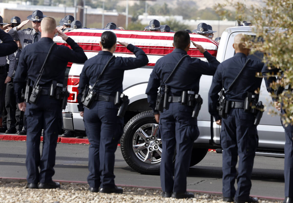 Law enforcement officers salute as casket carrying Nevada Highway Patrol Sgt. Michael Abbate ar ...