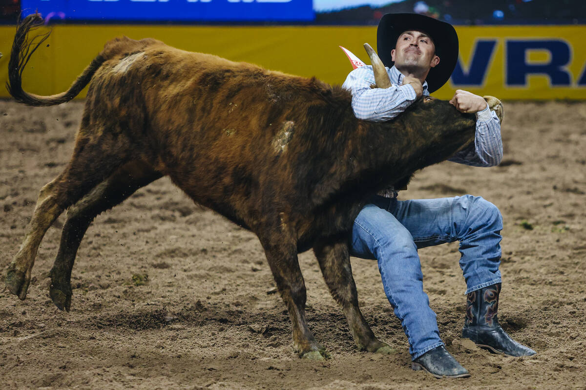 Jesse Brown wrestles his steer during the steer wrestling portion of the National Finals Rodeo ...