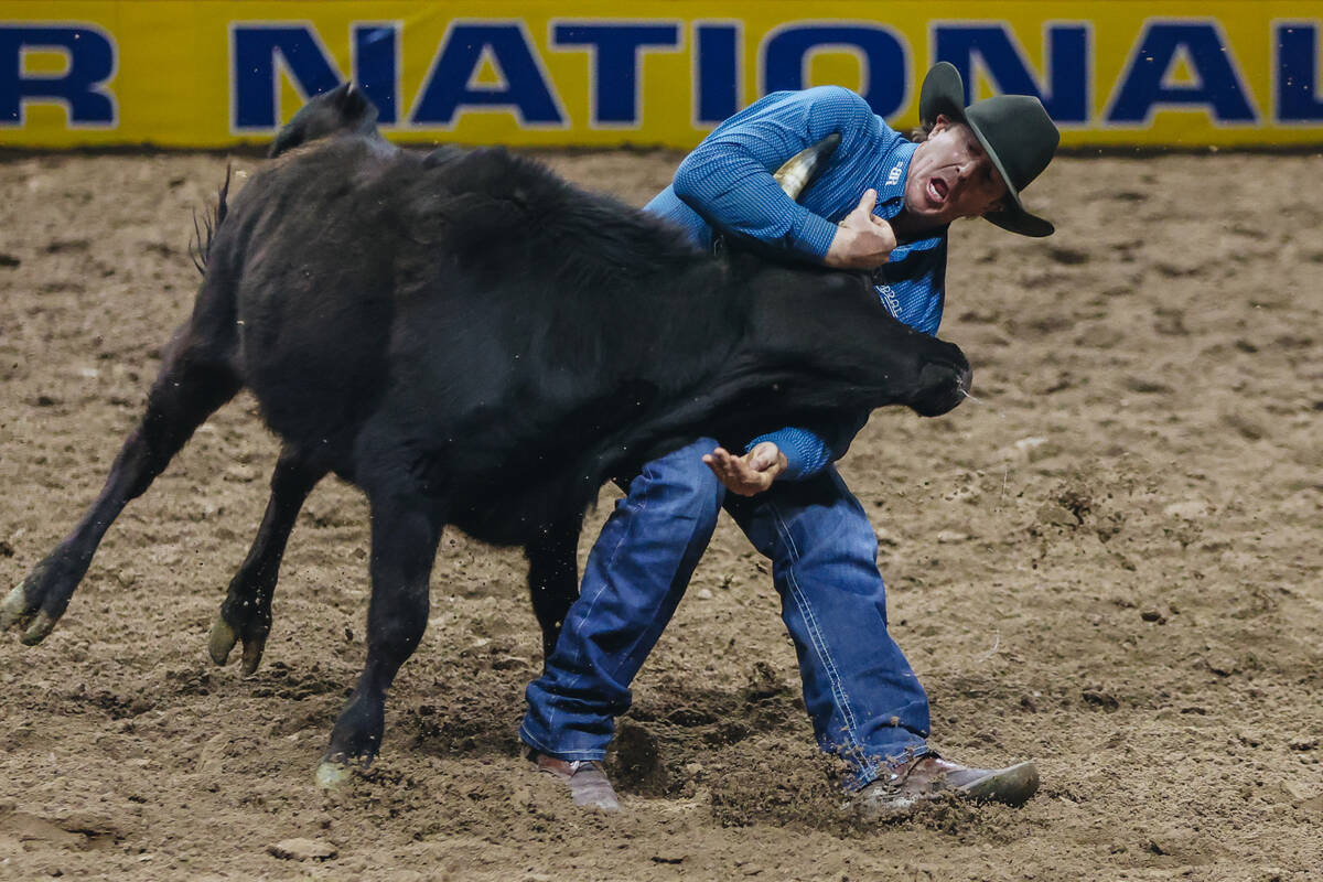 Nick Guy wrestles a steer during day three of the National Finals Rodeo at the Thomas & Mack Ce ...
