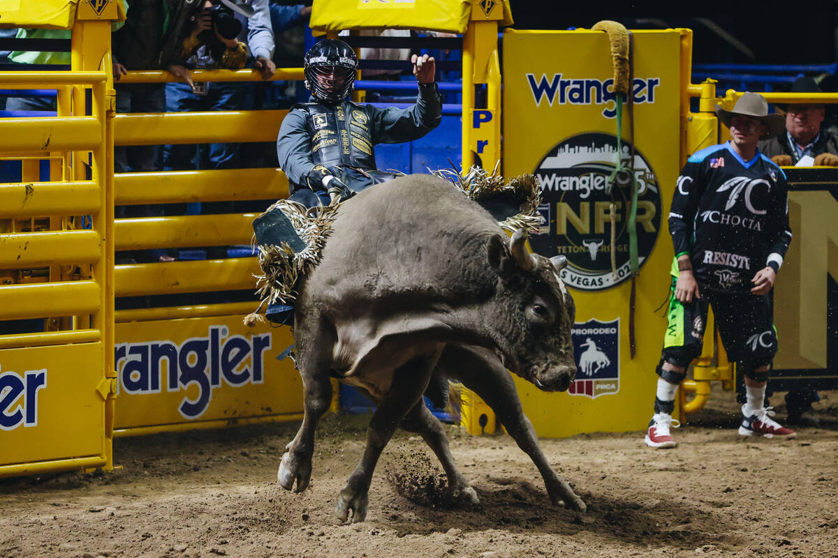 Sage Steele Kimzey rides a bull during day three of the National Finals Rodeo at the Thomas &am ...