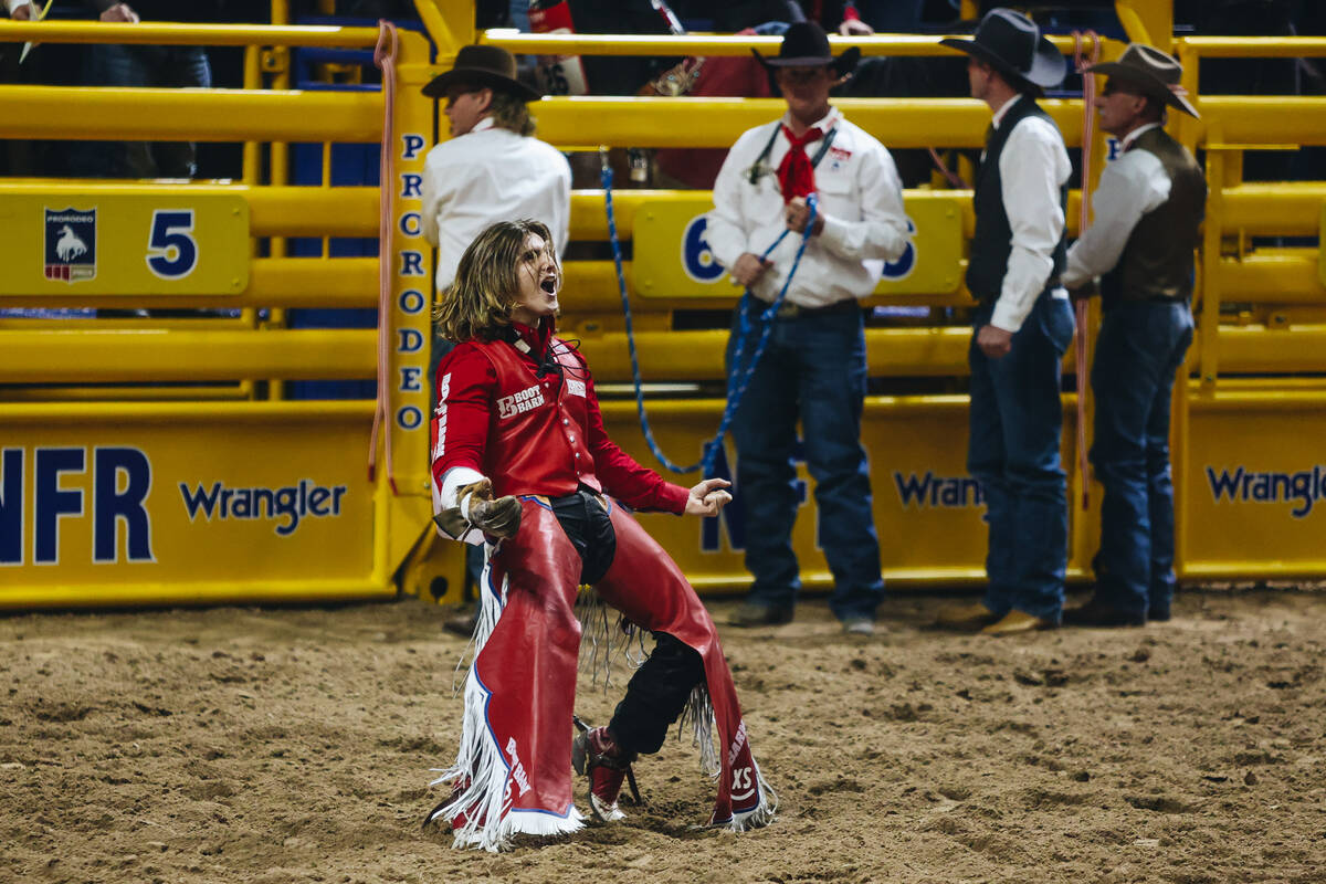 Rocker Steiner celebrates an 87 point ride during round one of bareback riding at NFR at the Th ...