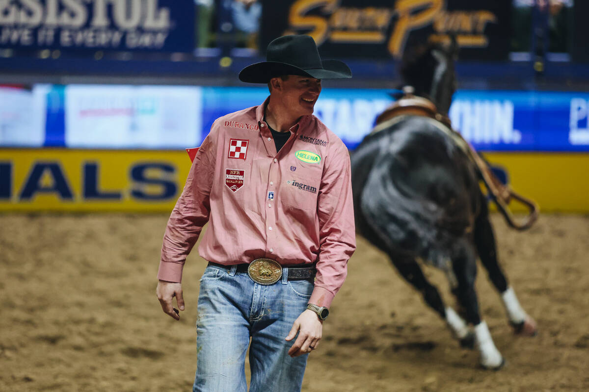 Ty Erickson celebrates a quick time result during the steer wrestling portion of NFR at the Tho ...