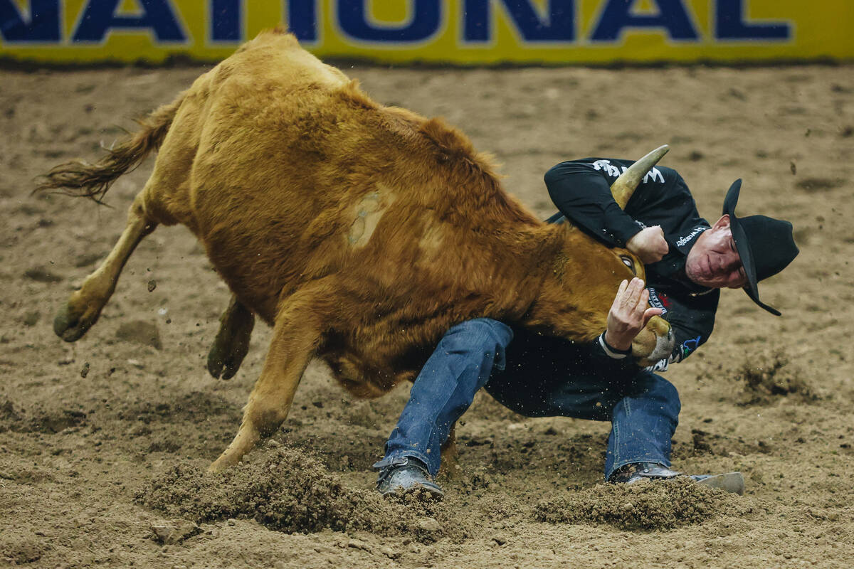 Dalton Massey wrestles his steer for a final time result of 3.5 seconds during the steer wrestl ...