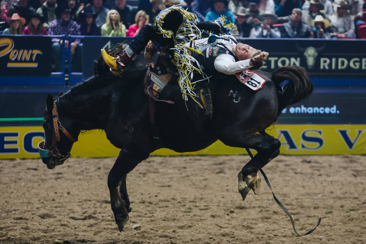Jacob Lees rides Scarlett Belle during round one of bareback riding at NFR in the Thomas & ...