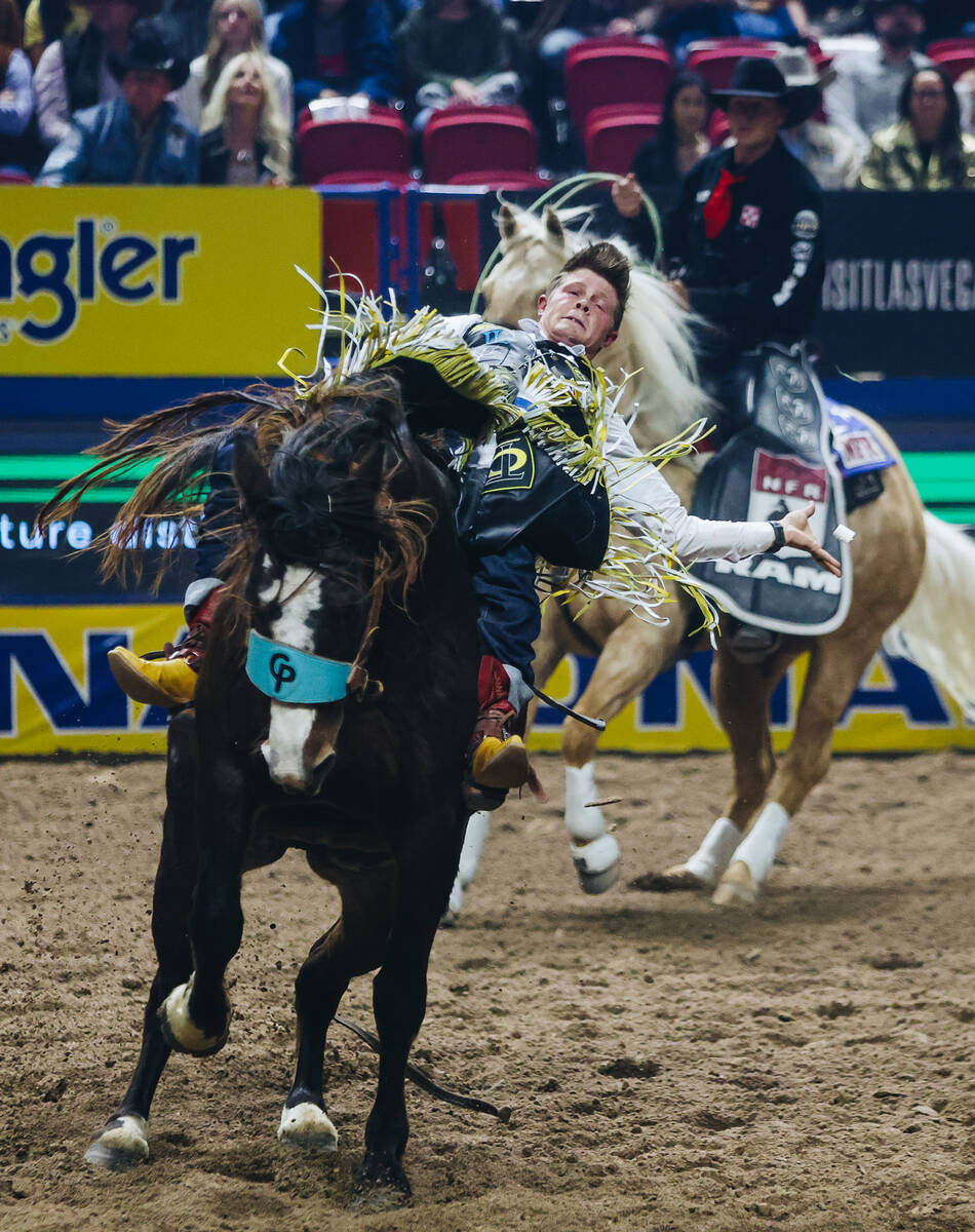 Jacob Lees rides Scarlett Belle during round one of bareback riding at NFR in the Thomas & ...