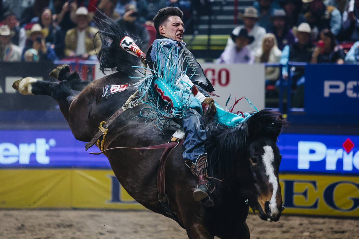 Jess Pope rides True Grit during round one of bareback riding at NFR in the Thomas & Mack C ...
