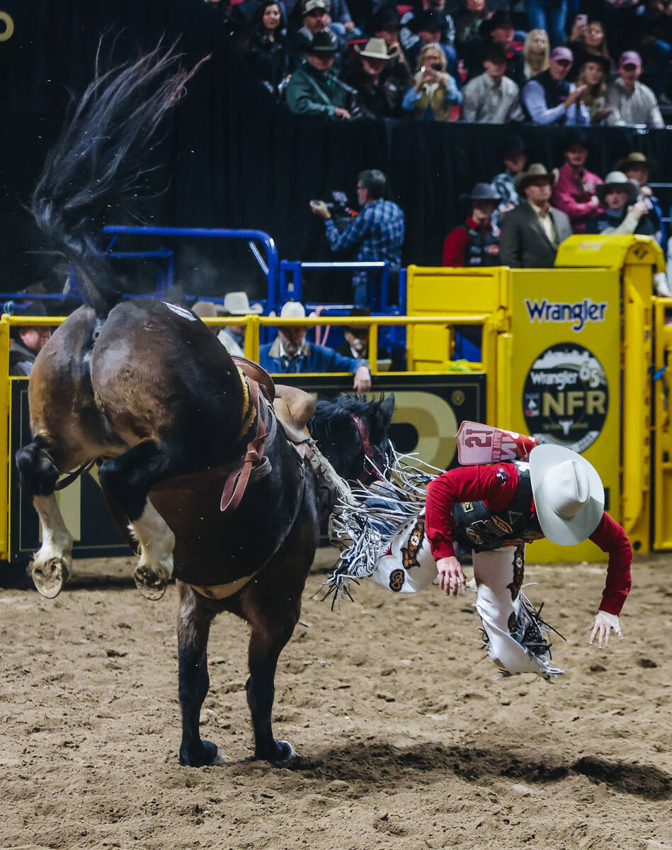 Chase Brooks falls off of Get Down during the National Finals Rodeo at the Thomas & Mack Ce ...