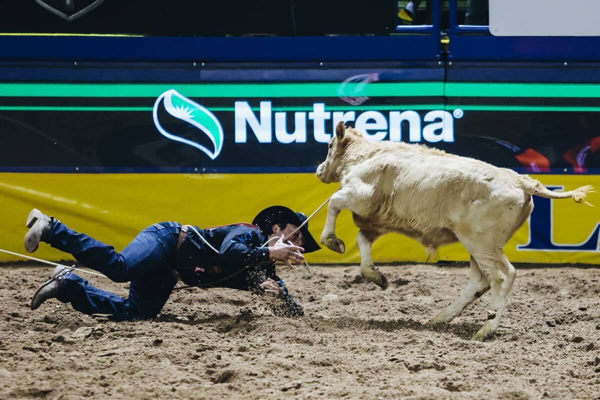 Ty Harris trips on his rope while trying to get to the calf during