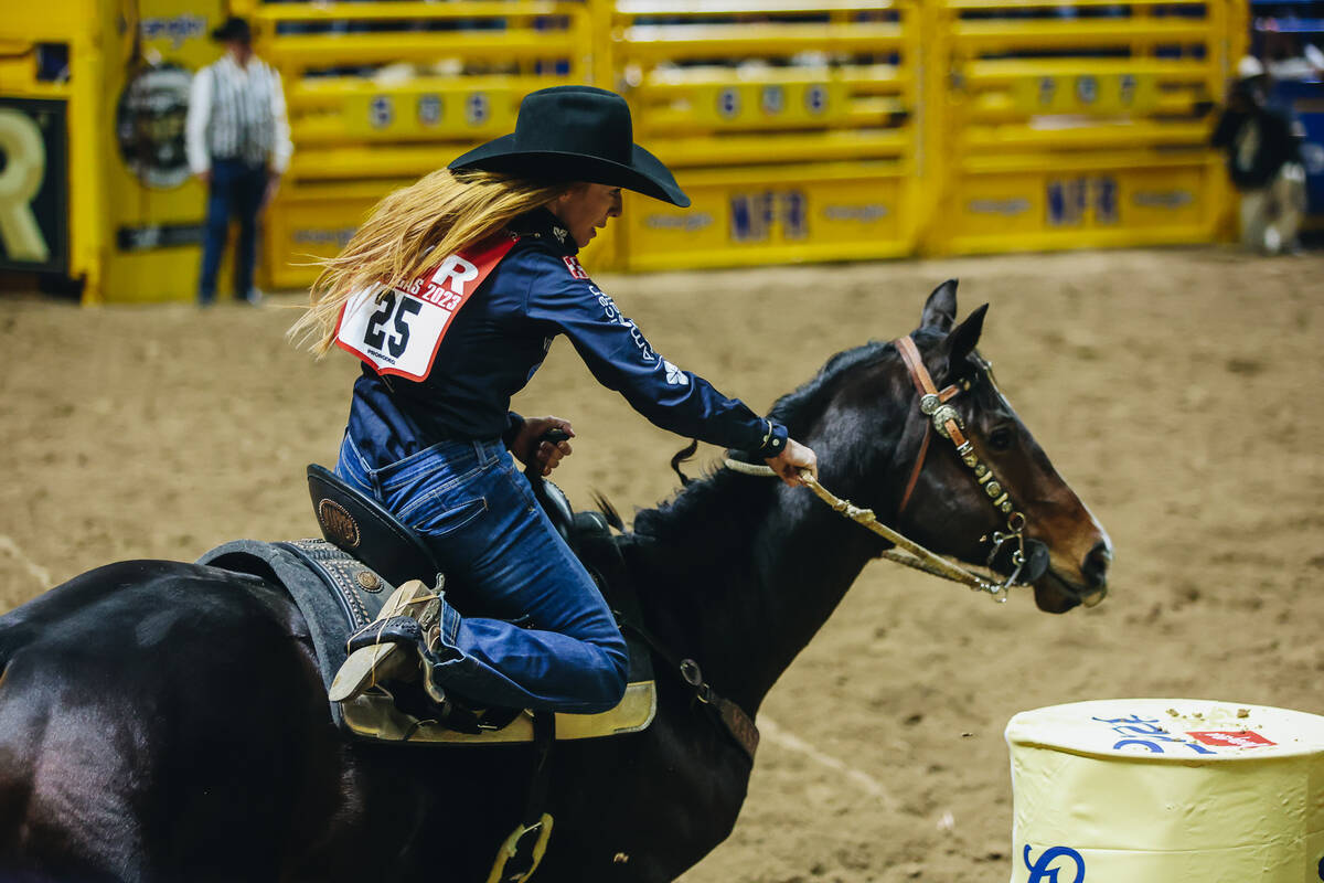 Emily Beisel rounds the barrel during day three of the National Finals Rodeo at the Thomas & ...