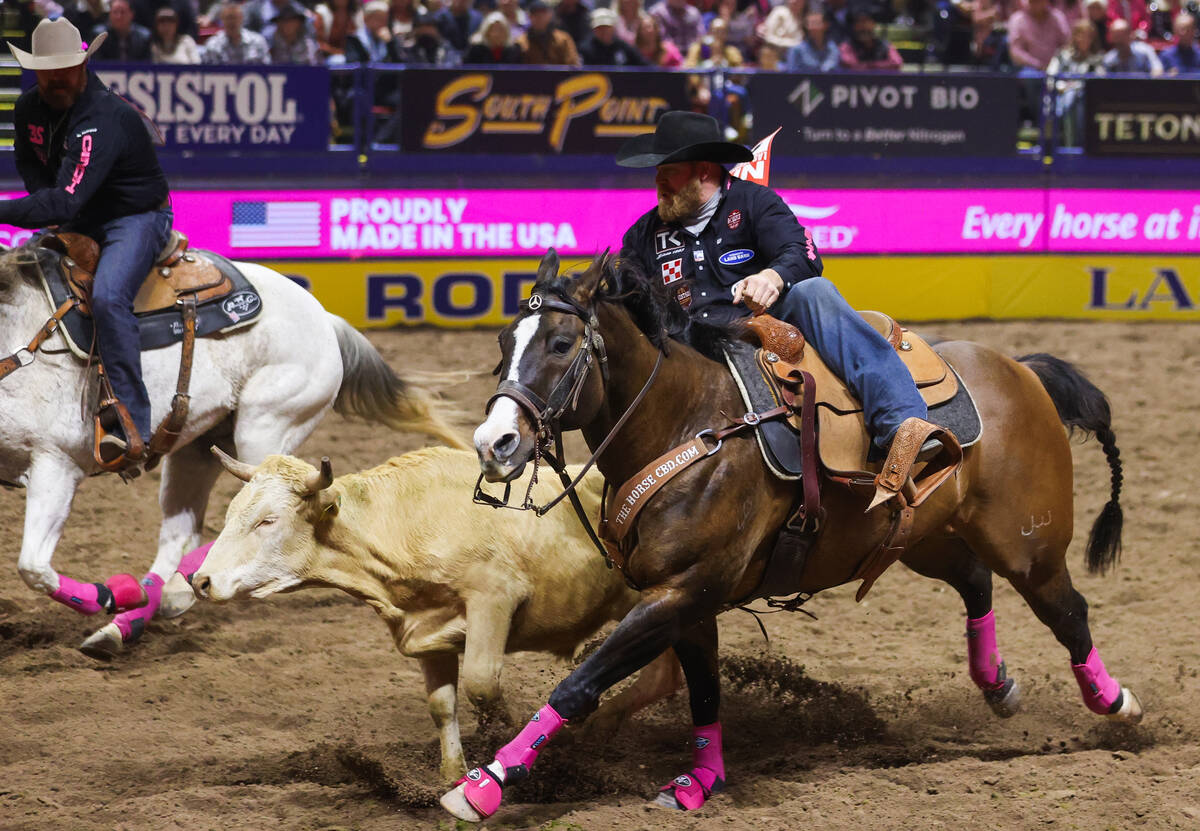 Will Lummus rides into position for steer wrestling while he competes in steer wrestling on day ...