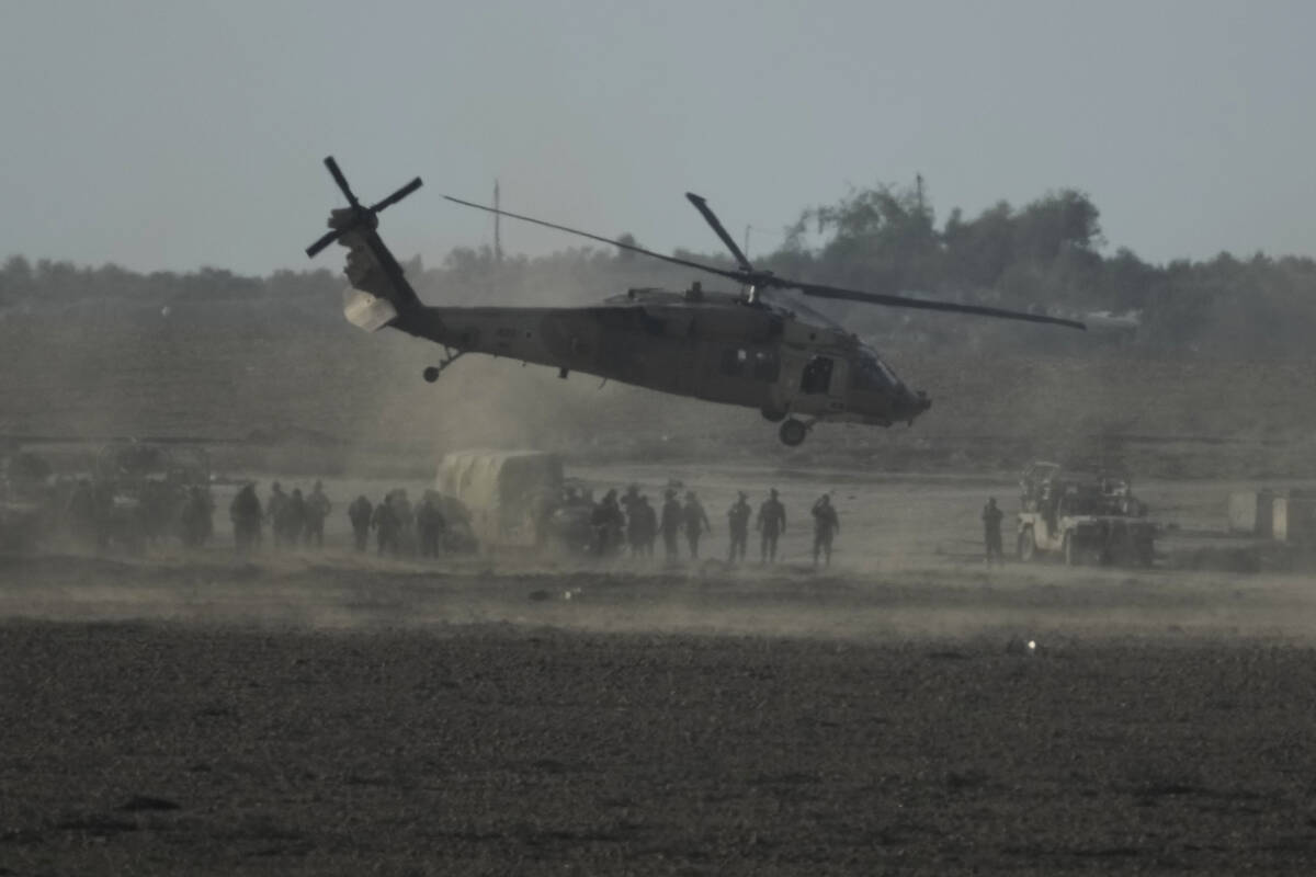 Israeli military helicopter lands near the Gaza Strip border on Saturday, Dec. 9, 2023. (AP Pho ...