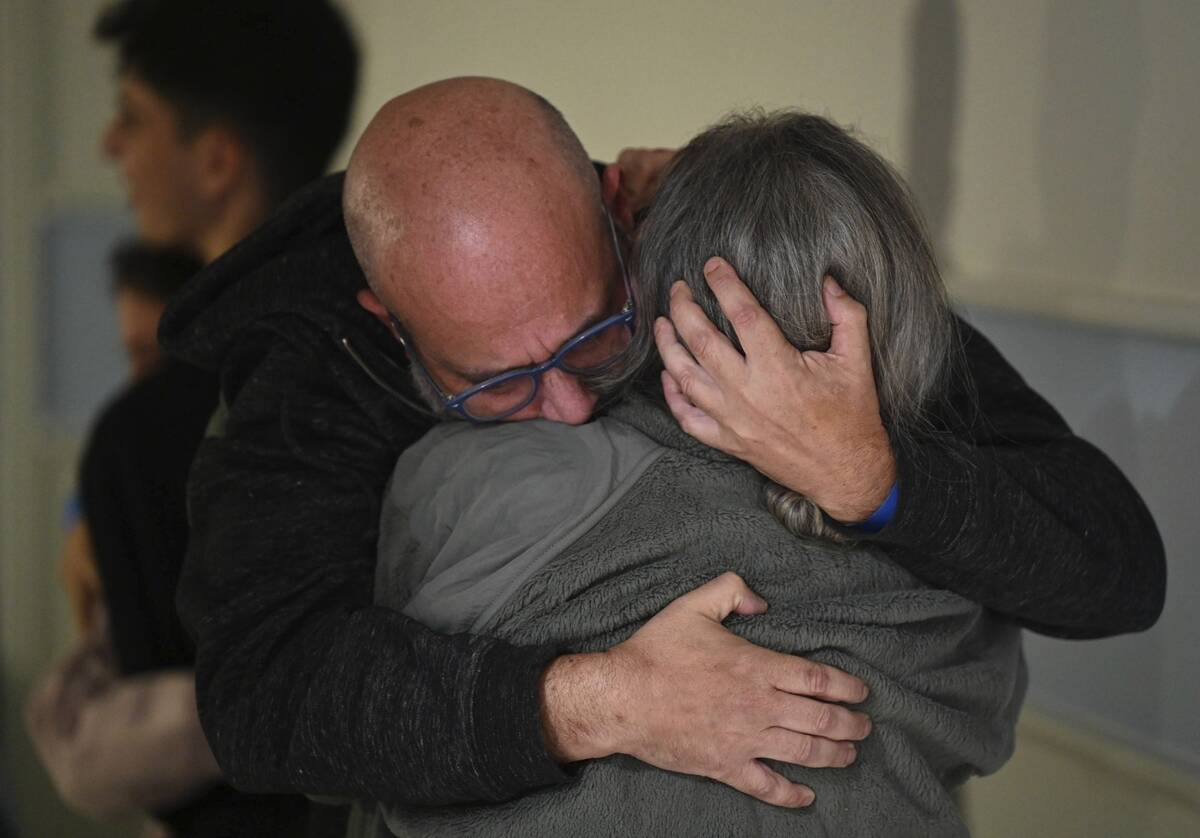 FILE - This handout photo provided by Haim Zach/GPO shows Sharon Hertzman, right, hugging her h ...