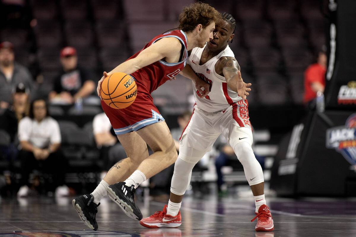UNLV Rebels guard Jackie Johnson III (24) defends against Loyola Marymount Lions guard Will Joh ...