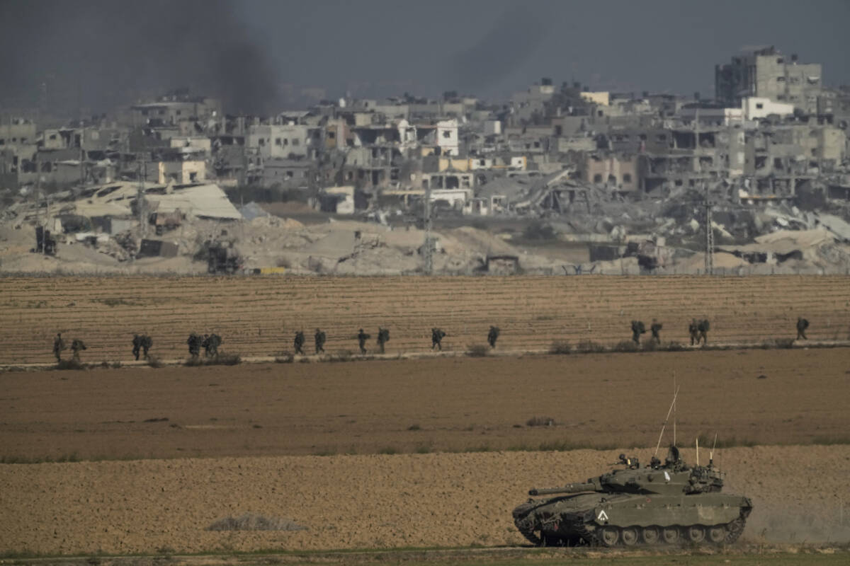 Israeli troops are seen near the Gaza Strip border, in southern Israel on Sunday, Dec. 10, 2023 ...