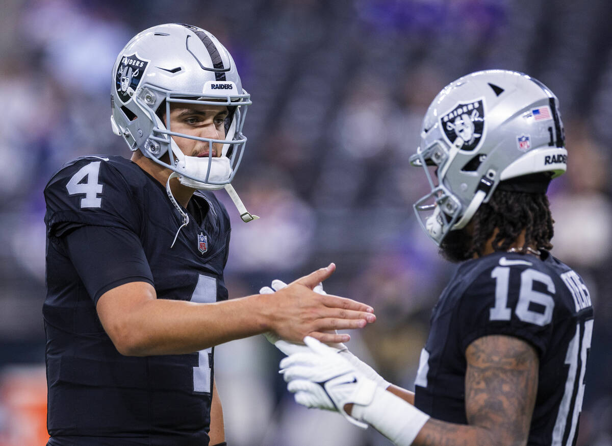 Raiders quarterback Aidan O'Connell (4) greets wide receiver Jakobi Meyers (16) during warmups ...