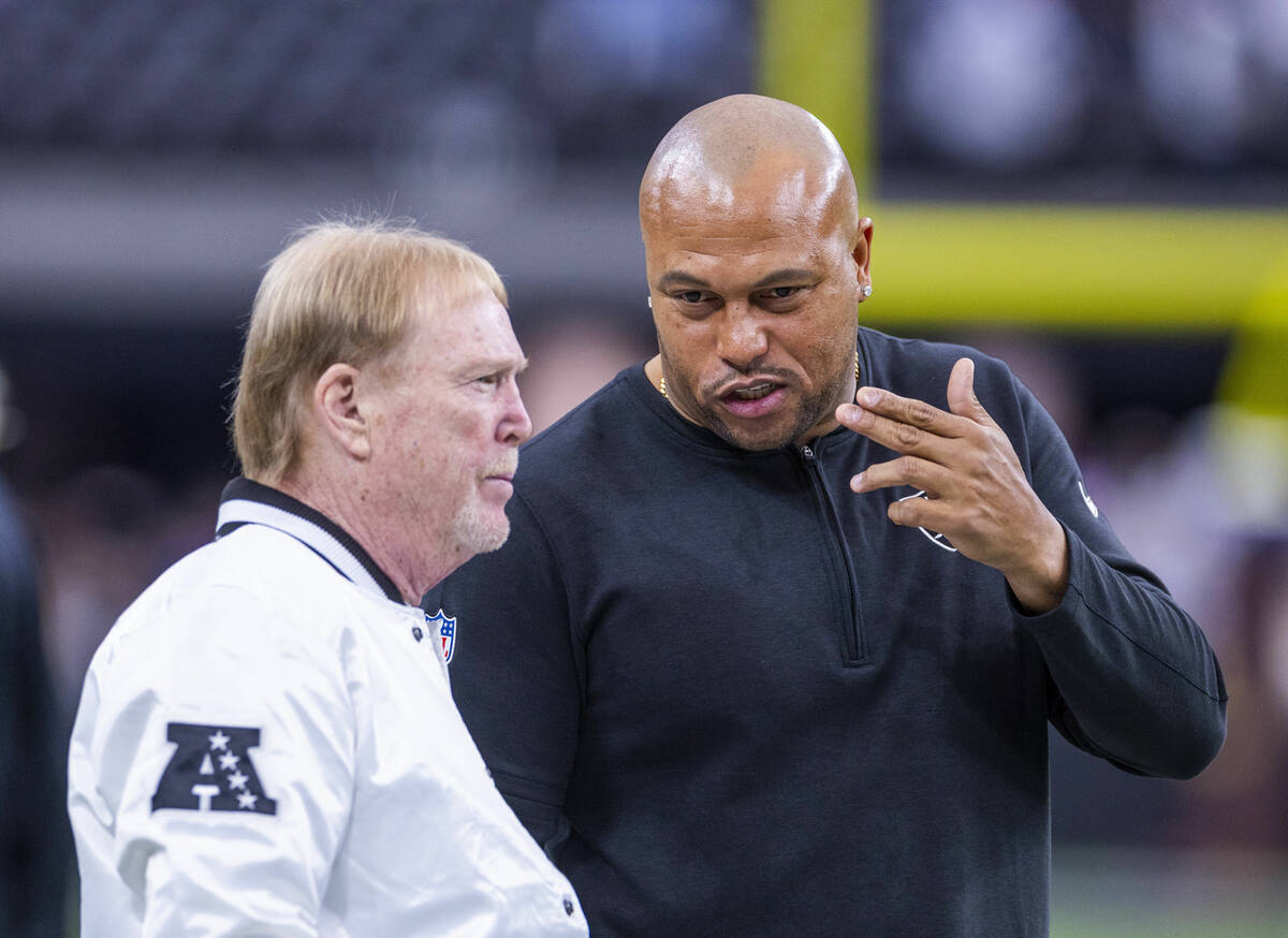 Raiders owner Mark Davis chats with interim head coach Antonio Pierce during warmups before the ...