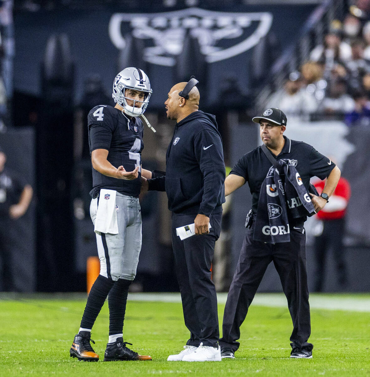 Raiders quarterback Aidan O'Connell (4) speaks with interim head coach Antonio Pierce against t ...