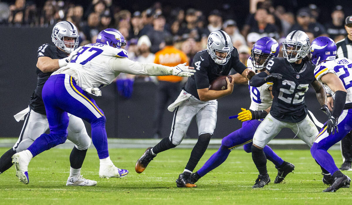 Raiders quarterback Aidan O'Connell (4) attempts to run for a first down as Minnesota Vikings d ...