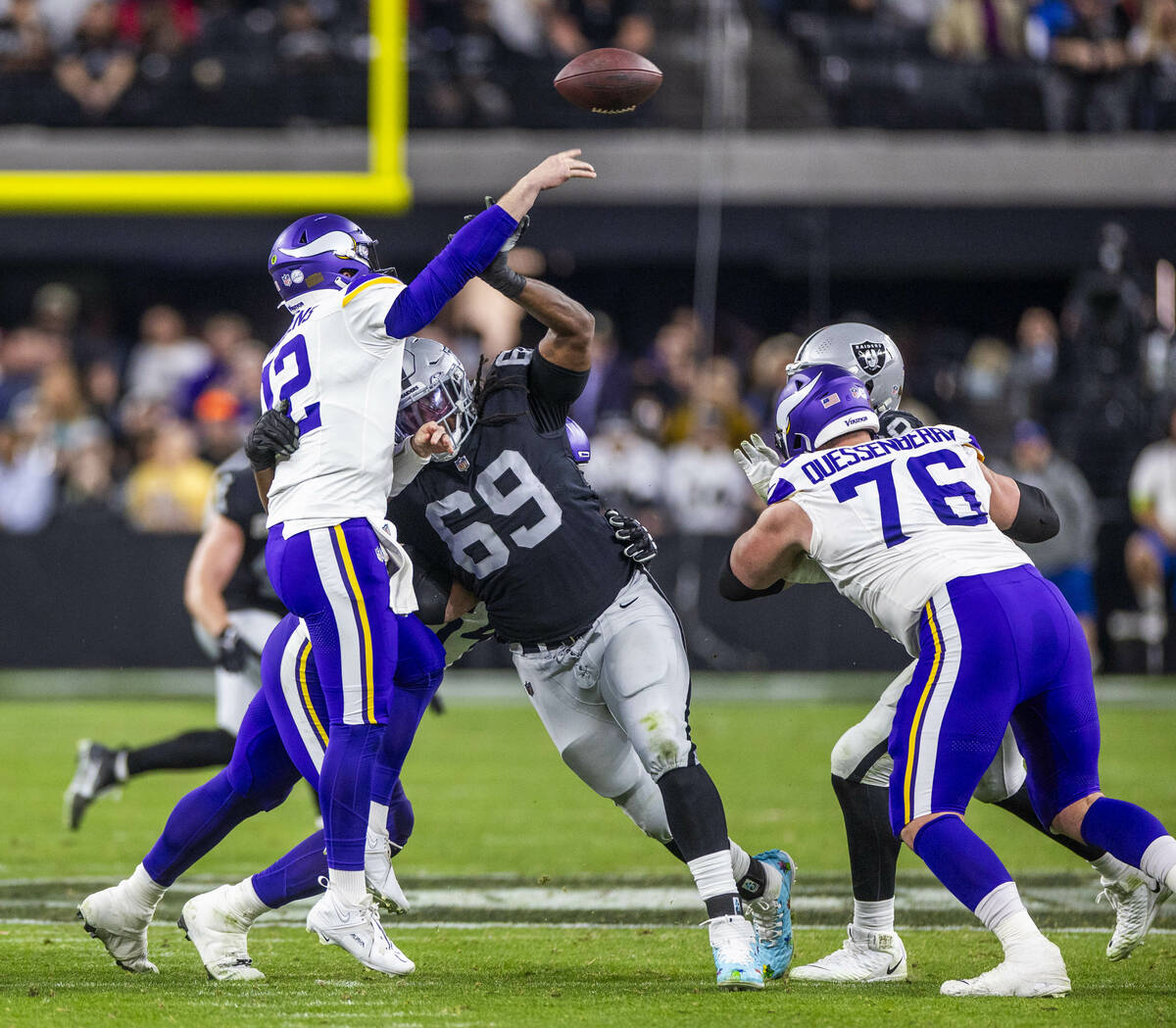 Minnesota Vikings quarterback Nick Mullens (12) just gets off a pass as he's hit by Raiders def ...