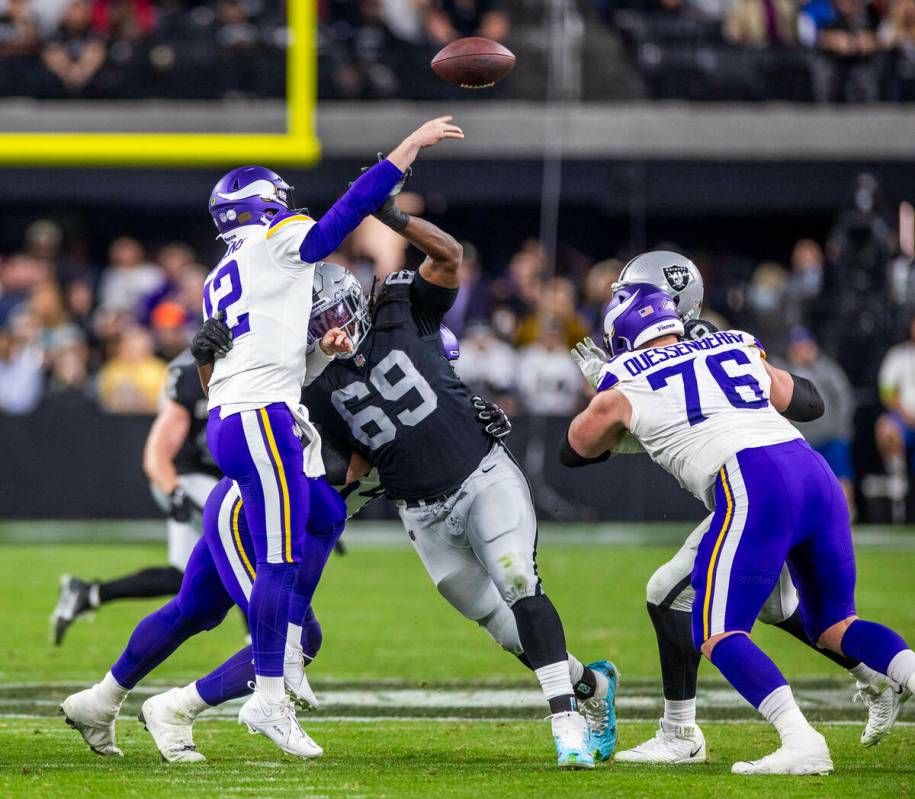 Minnesota Vikings quarterback Nick Mullens (12) just gets off a pass as he's hit by Raiders def ...
