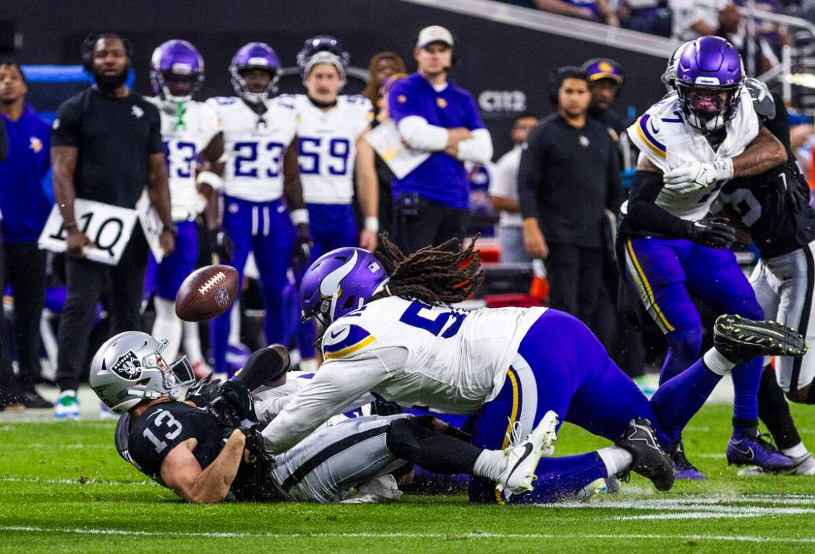 Raiders wide receiver Hunter Renfrow (13) fumbles the ball after a big hit by Minnesota Vikings ...