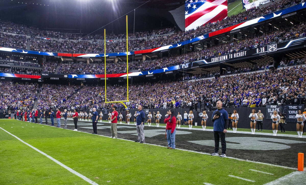 UNLV representatives participate in a moment of silence on the goal line before the start of th ...
