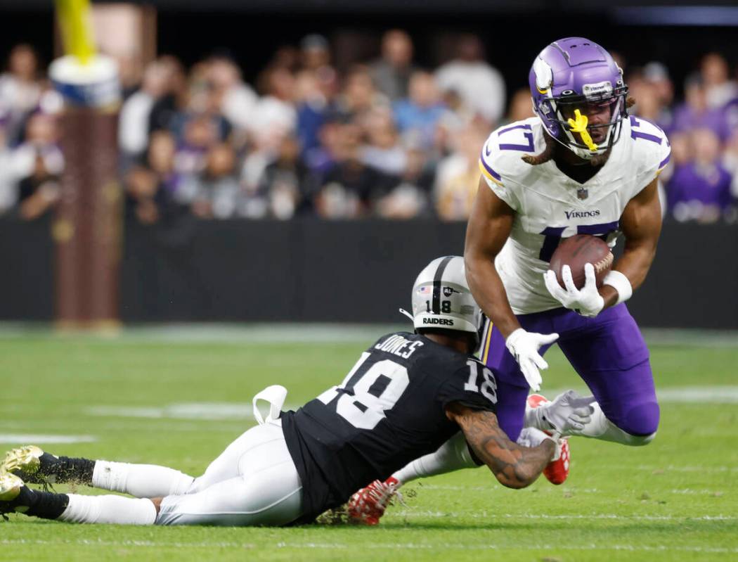 Raiders cornerback Jack Jones (18) tackles Minnesota Vikings wide receiver K.J. Osborn (17) dur ...