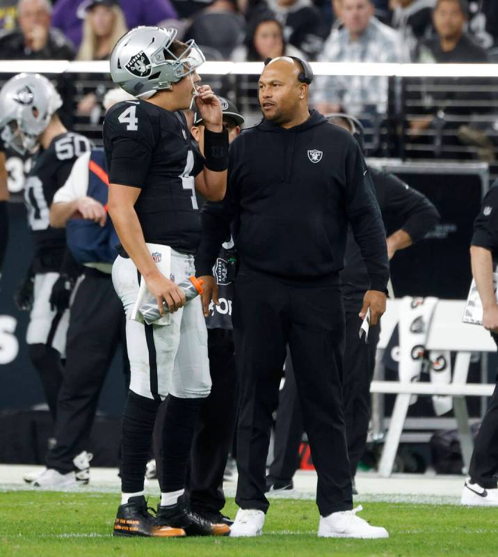 Raiders quarterback Aidan O'Connell (4) listens to Interim Head Coach Antonio Pierce during the ...