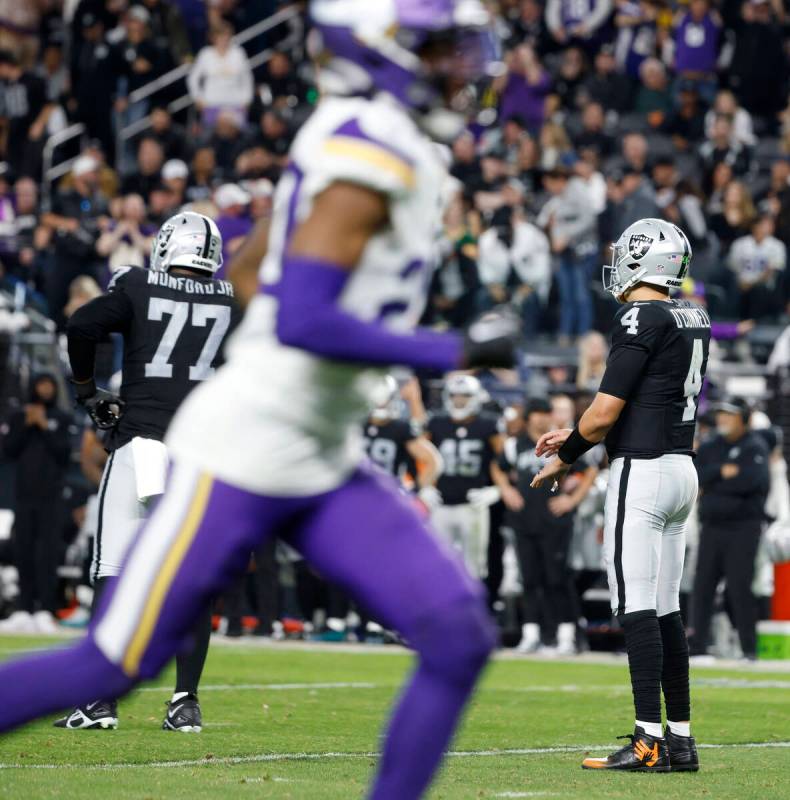Raiders quarterback Aidan O'Connell (4) and Raiders offensive tackle Thayer Munford Jr. (77) wa ...